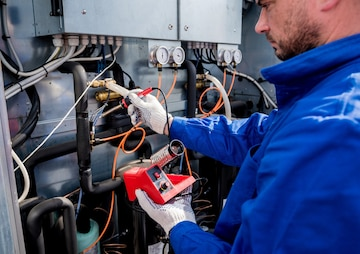 Technician repairing commercial fridge