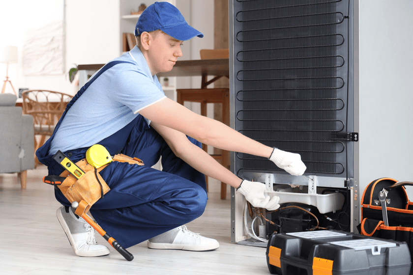 Routine maintenance on commercial fridge