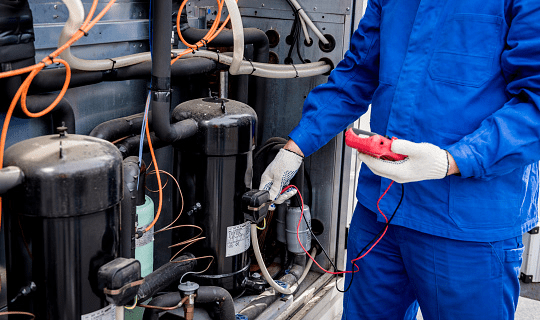 Technician repairing commercial refrigerator